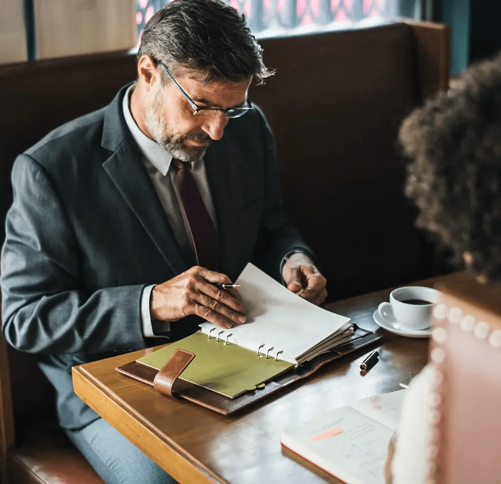 Texas real estate attorney reviewing deed documents with a client across a table